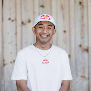 In 2024, Hazim Ahmad smiles brightly while wearing Red Bull branded apparel in Fuschl am See, Austria