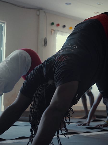 Yoga practioners perform the pose downward facing dog