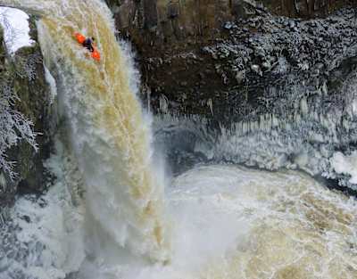 Kayaker Luke Spencer drops into a waterfall at Outlet Falls, USA.
