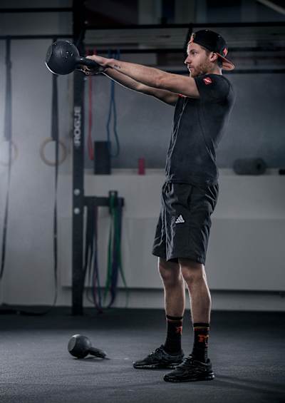 The explosive kettlebell swing being perfumed by an athlete.