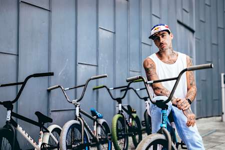 Kriss Kyle poses for a portrait on a bike.