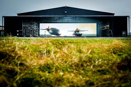 Paul Bonhomme and Steve Jones fly through a hangar at Red Bull Barnstorming