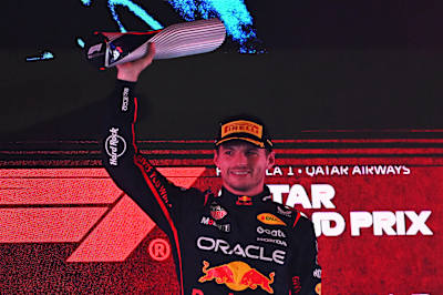 Max Verstappen lifts his trophy on the podium during the F1 Grand Prix of Qatar at Lusail International Circuit on November 30, 2025 in Lusail City, Qatar.