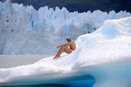 A swimmer sits on ice at the Perito Moreno Glacier, Argentina. 