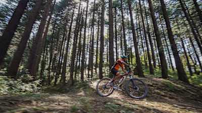 A participant rides a trail at MTB Himalaya