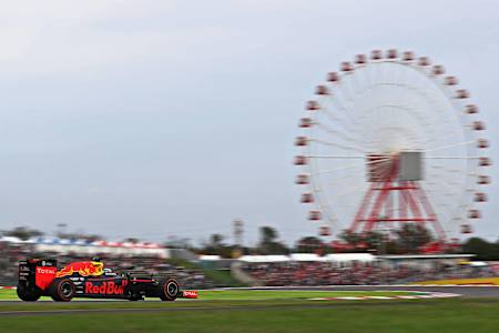 Daniel Ricciardo passes the famous Ferris wheel