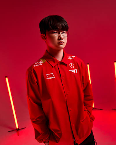Faker from T1 Esports is captured during a dynamic Red Bull photoshoot in South Korea on 10 July, 2025, set against a bold red backdrop and striking lights.