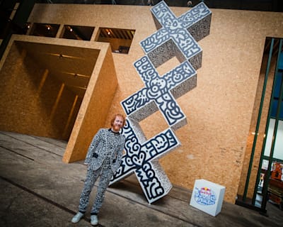 British artist and Red Bull Doodle Art World Final judge Sam Cox, better known as Mr Doodle, poses with an art piece he created at Amsterdam's STRAAT Museum on April 13, 2023.