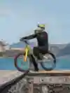 Danny MacAskill poses on his bike in front of Alcatraz Island.