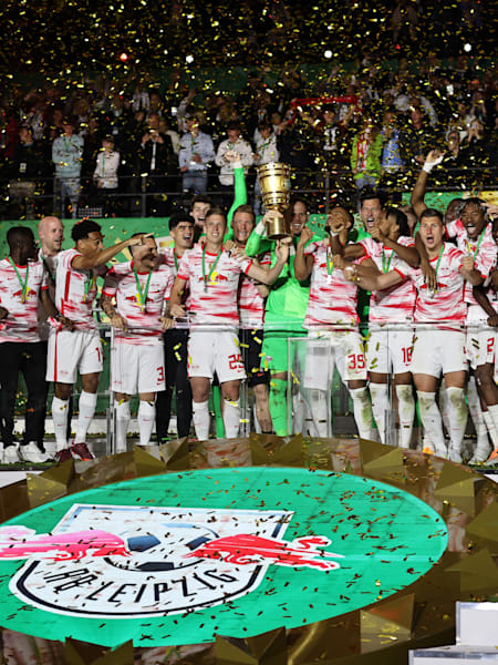RB Leipzig captain Peter Gulacsi receives the DFB Cup in a golden shower of confetti. 