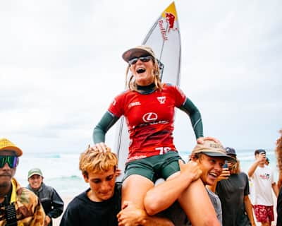 Surfer Caitlin Simmers gets chaired up the beach after winning the 2024 Lexus Pipe Pro in Hawaii.