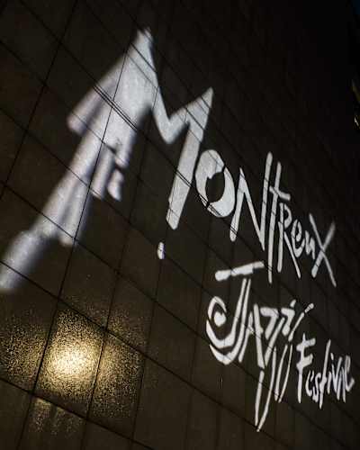 The Montreux Jazz Festival logo projected on a wall outside of of the event's venues in the Swiss city