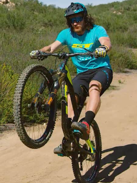 Mountain biker Wyn Masters demonstrates how to perform a manual wheelie
