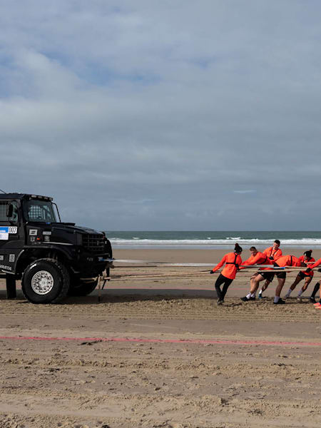 England players pull a truck across the beach in Jersey for Red Bull Stress Test
