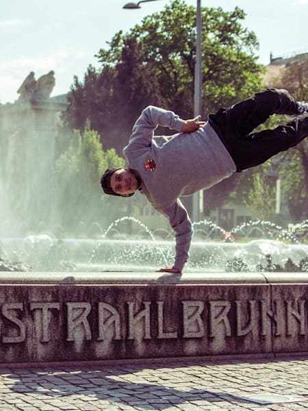 B-Boy RoxRite poses on the Hochstrahlbrunnen Fountain in Vienna.