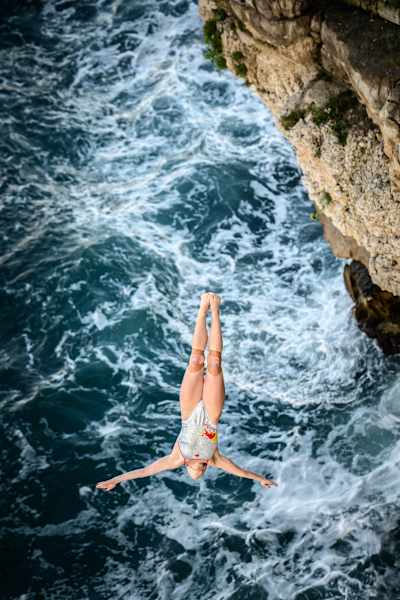 Molly Carlson of Canada launches from the 20-metre balcony during the 2026 Red Bull Cliff Diving World Series finale in Polignano a Mare, Italy
