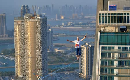 Jaan Roose slacklining between the Crescent Towers in Doha, Qatar on 19 June, 2023.