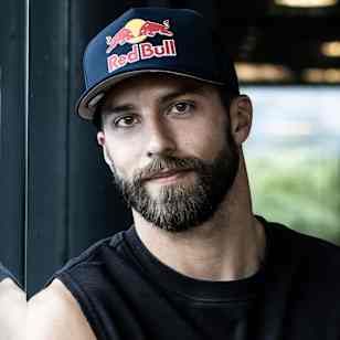 In 2025, Alexander Rončević stands in Salzburg, Austria, wearing a Red Bull-branded cap and sleeveless top.