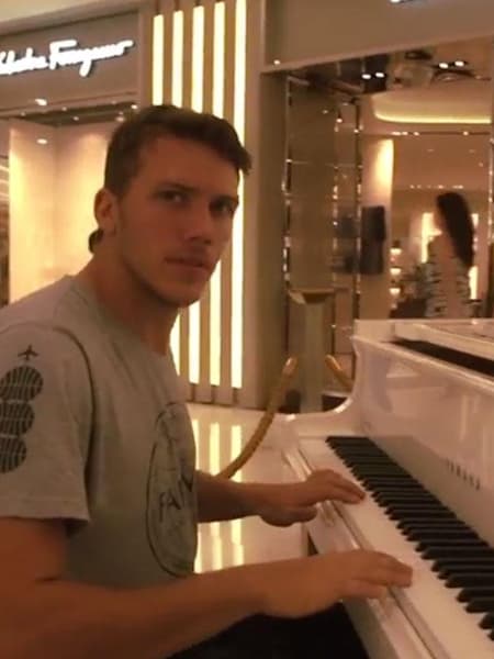 Jason Paul playing a piano in a Bangkok shopping centre