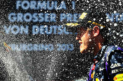 Sebastian Vettel celebrates on the podium after winning the German Grand Prix at the Nuerburgring on July 7, 2013 in Nuerburg, Germany. 