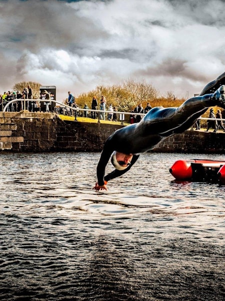 Person dives into canal during Neptune Steps event.