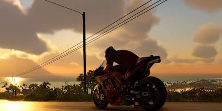 Zrzut ekranu z gry The Crew Motorfest przedstawia motocykl Red Bull KTM jadący w stronę zachodu słońca.