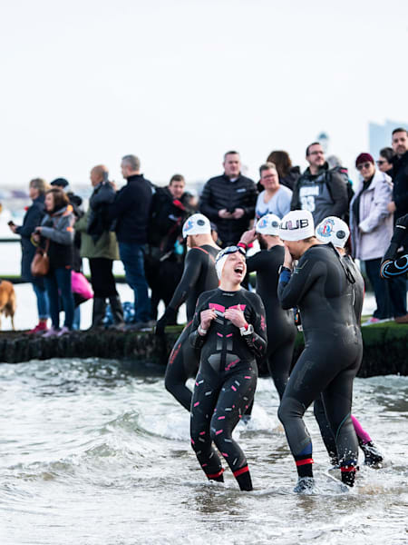 Swimmers head into the sea to join Ross for his final swim