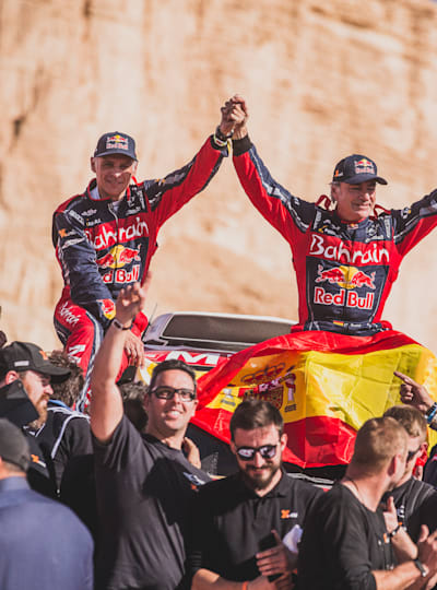 Carlos Sainz and Lucas Cruz celebrate a third Dakar Rally title