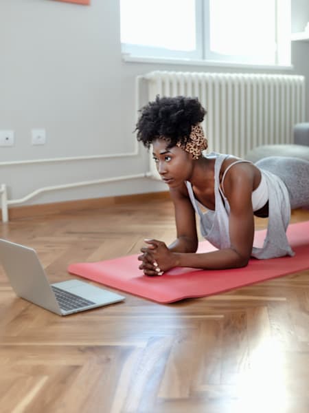 Woman does home workout in her living room