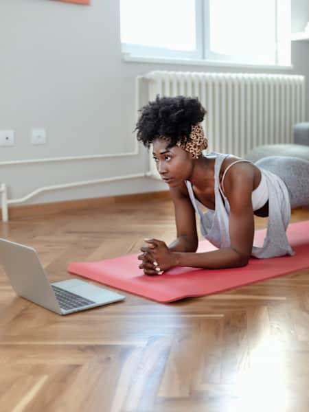 Woman does home workout in her living room