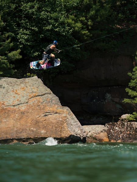 With the use of a high powered winch, Mike Dowdy wakeboards on natural features along the shores of Lake Superior in northern Wisconsin, USA on July 10, 2017.