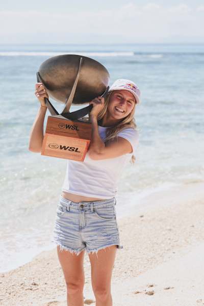 2025 WSL world champion Molly Picklum poses with the title trophy on Tavarua Island in Fiji