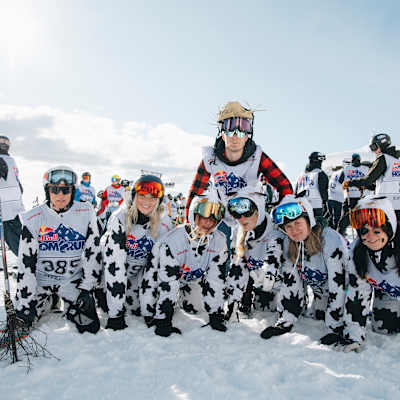 In 2023, Red Bull participants wearing cow-print outfits pose cheerfully on snowy slopes at the Homerun event in Are, Sweden