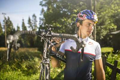 Szymon Godziek carries his road bike on his way to attempting a backflip over the Tour de Pologne on Aug. 4, 2017