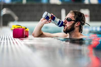 Triathlete George Benson uses a variety of different swimming aids