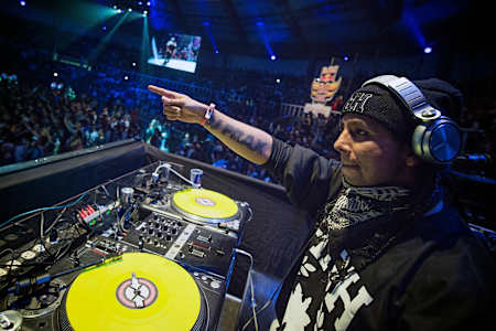 DJ Prax hyping up the crowd and the dancers.