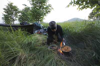 Arjun Bhogal cooking during a stop in Germany