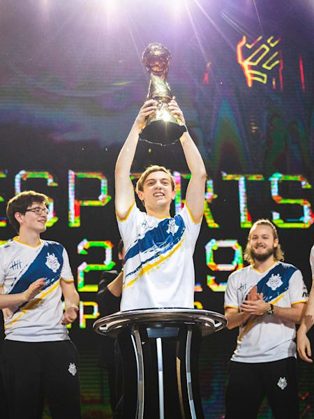 G2 Esports holding up the Mid-Season Invitational trophy.