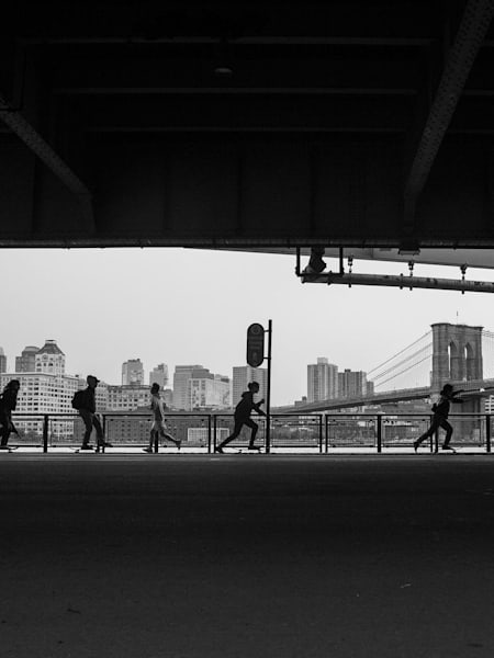 The BRUJAS skate beneath a New York City bridge.