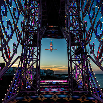 Owen Weymouth of the UK dives from the 27.5 metre platform at sunset at the Red Bull Cliff Diving World Series at Polignano a Mare, Puglia, Italy on September 25, 2021. 
