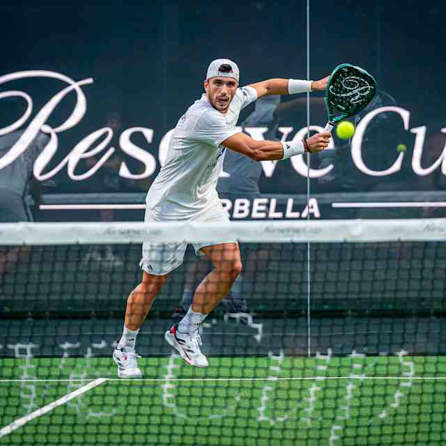 An electrifying moment at the Reserve Cup Marbella 2025, as a padel player smashes a forehand during a thrilling match on the prestigious court