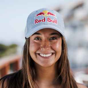 In 2025, Dominique Charrier smiles brightly wearing a Red Bull cap in Chile.