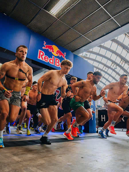 Les participants d'une compétition HYROX s'élancent sur le parcours, prêts à relever un défi mêlant course à pied, force et endurance.
