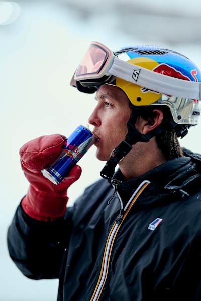 Snowboarder Scotty James sips a Red Bull energy drink in Perisher Village, Australia on August 27, 2025.