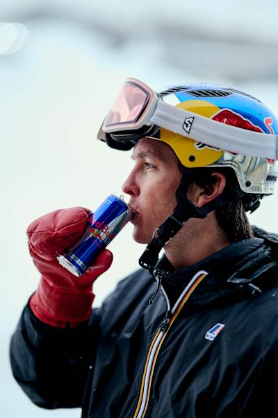 Snowboarder Scotty James sips a Red Bull energy drink in Perisher Village, Australia on August 27, 2025.