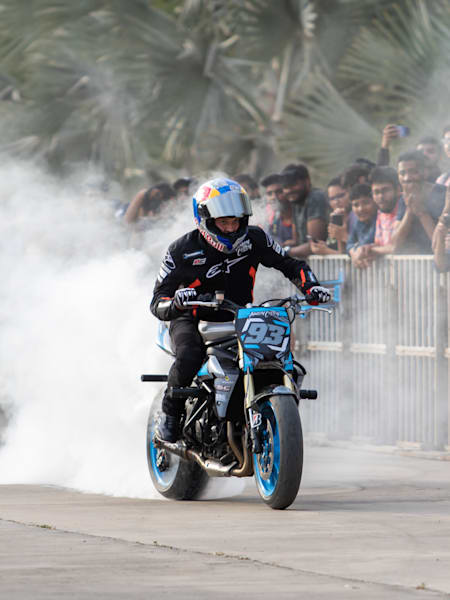 Aaron Colton performs a burnout on a motorcycle during a showcase.