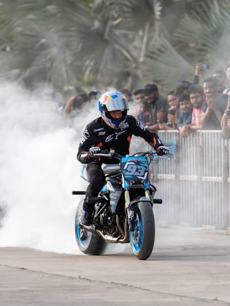 Aaron Colton performs a burnout on a motorcycle during a showcase.