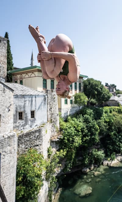 Molly Carlson of Canada dives from the 21 metre Stari Most (Old Bridge) during the fifth stop of the Red Bull Cliff Diving World Series in Mostar, Bosnia and Herzegovina on August 25, 2022.