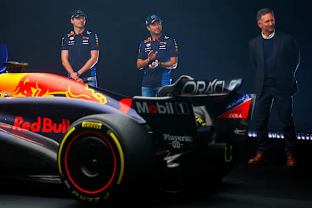 Max Verstappen and Sergio Perez and Red Bull Racing Team Principal Christian Horner stand with the RB20 during the RB20 car launch at factory on February 15, 2024 in Milton Keynes, England.