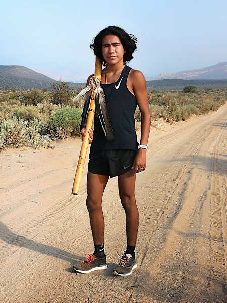 Ku Stevens, the founder of the Remembrance Run, carries a ceremonial staff in honor of his ancestors.